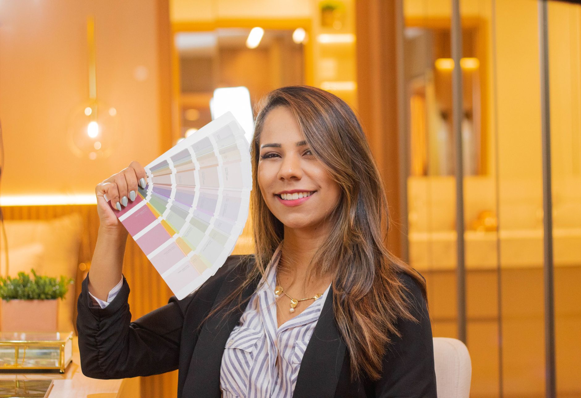 Person holding a fan of color samples